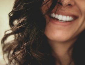 long black haired woman smiling close-up photography